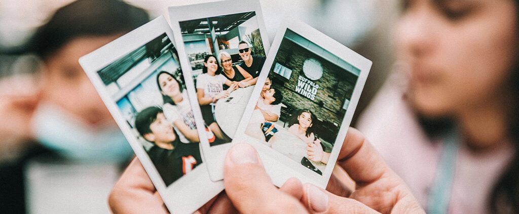 A hand holding some family photos