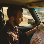 A man looking on a map and trying to find a way