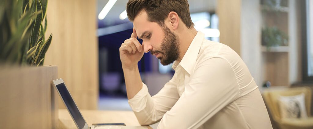 A man is pondering when he is working