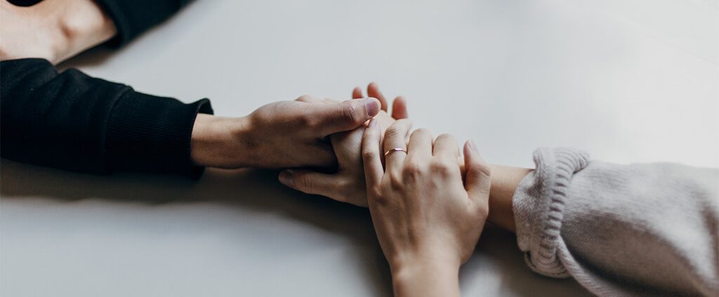Photo of a married couple holding hands
