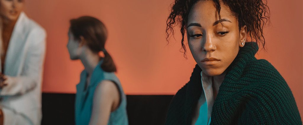 Woman looking away in disgust from her group