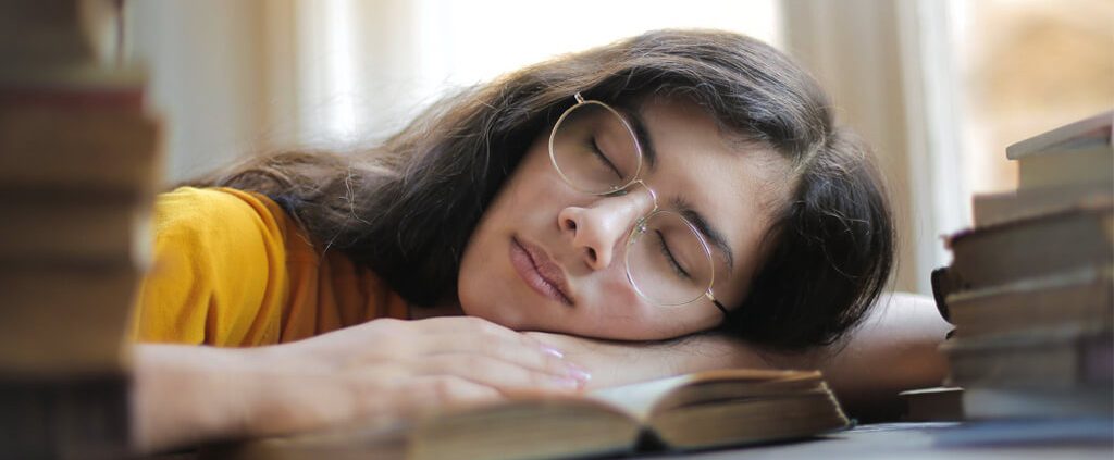 A woman fall asleep when reading bible