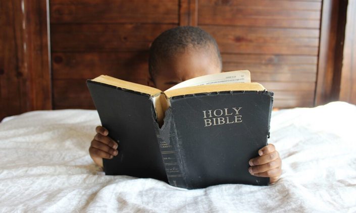 A child is reading bible
