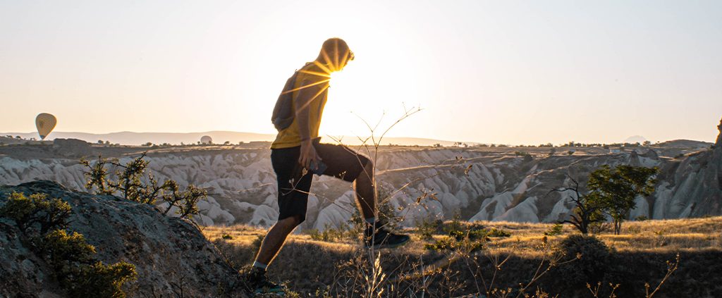 A man is standing on the rock formation