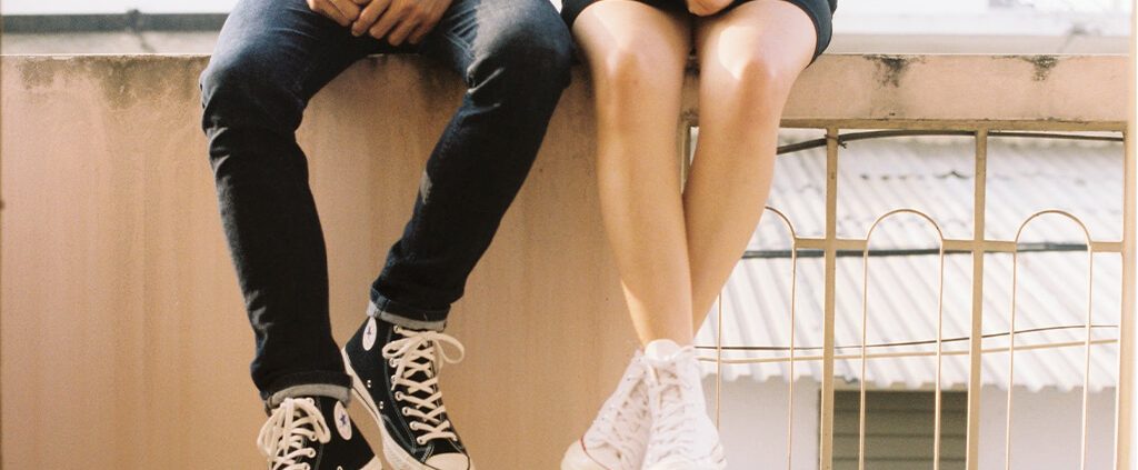 Couple sitting on a wall together