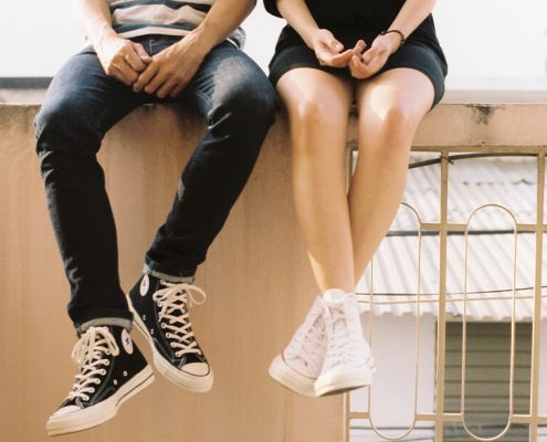 Couple sitting on a wall together