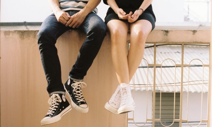 Couple sitting on a wall together