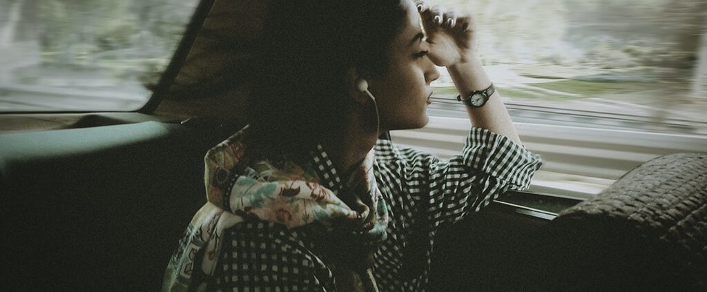 Woman looking out a car window