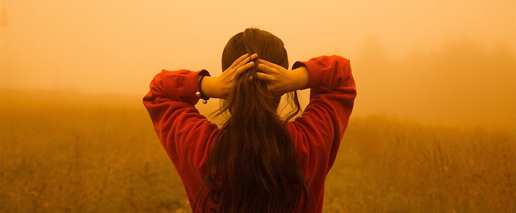 Lady facing backwards tying her hair