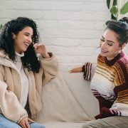 Two women chatting on a couch