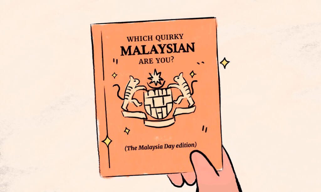 A hand holding a Malaysia Passport