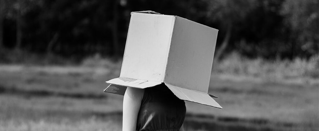 Girl with a box over her head