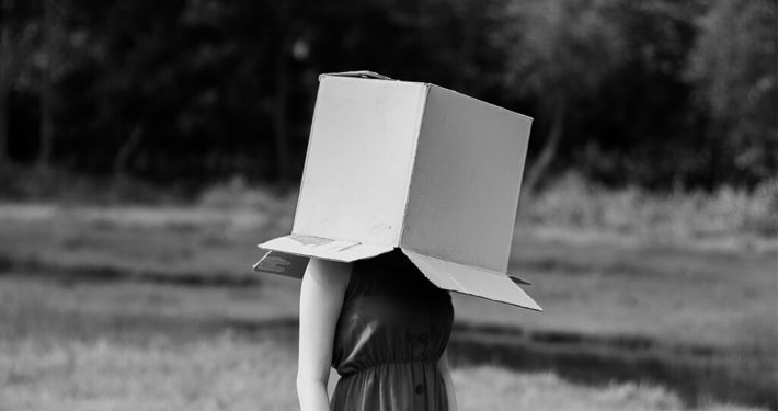 Girl with a box over her head