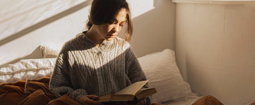 A woman is reading bible with a doubtful face