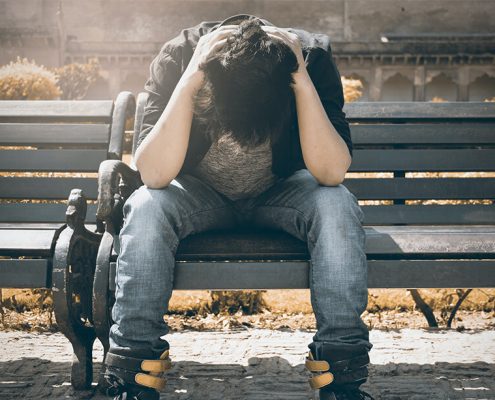 Guy stressed out, sitting on the bench