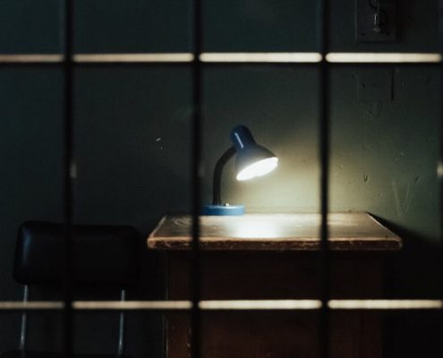 A study table in prison with the table lamp open