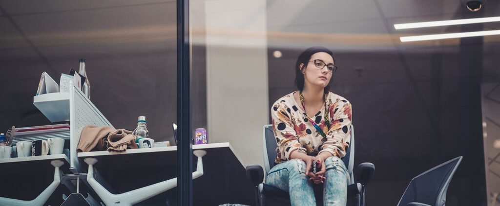 A woman looks depress and hopeless in her office