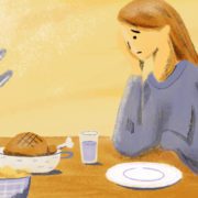 A woman feels reluctant to start her meal