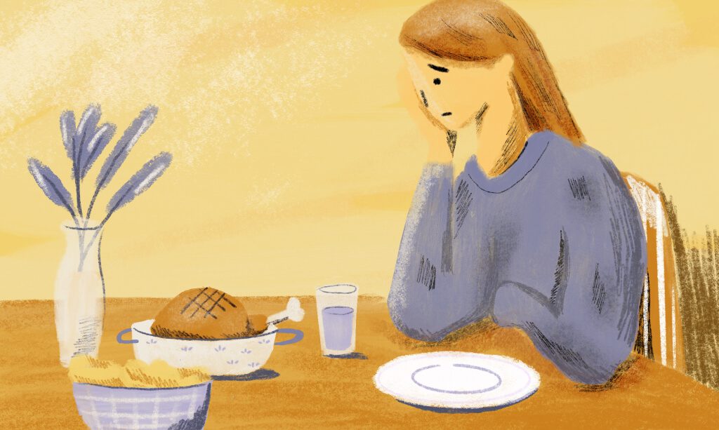 A woman feels reluctant to start her meal