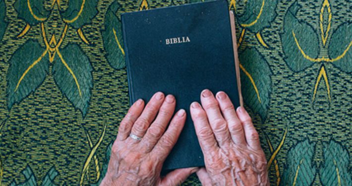 Bible with hands YMI ODB Devotion