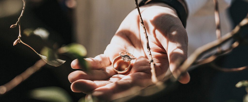 A hand with two engagement rings