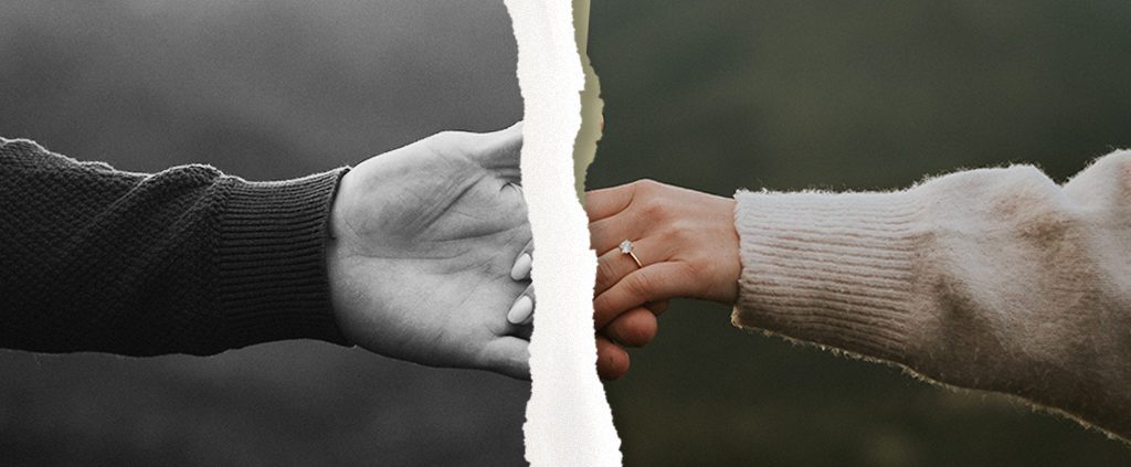Photo of couple holding hands torn in two