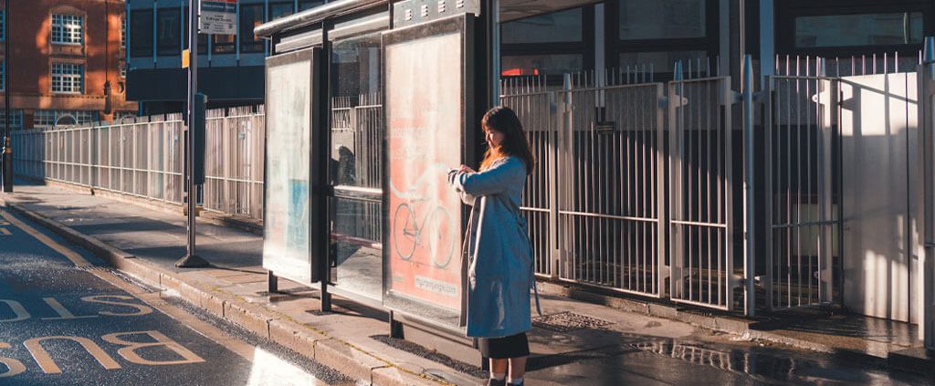 A woman is waiting for the bus