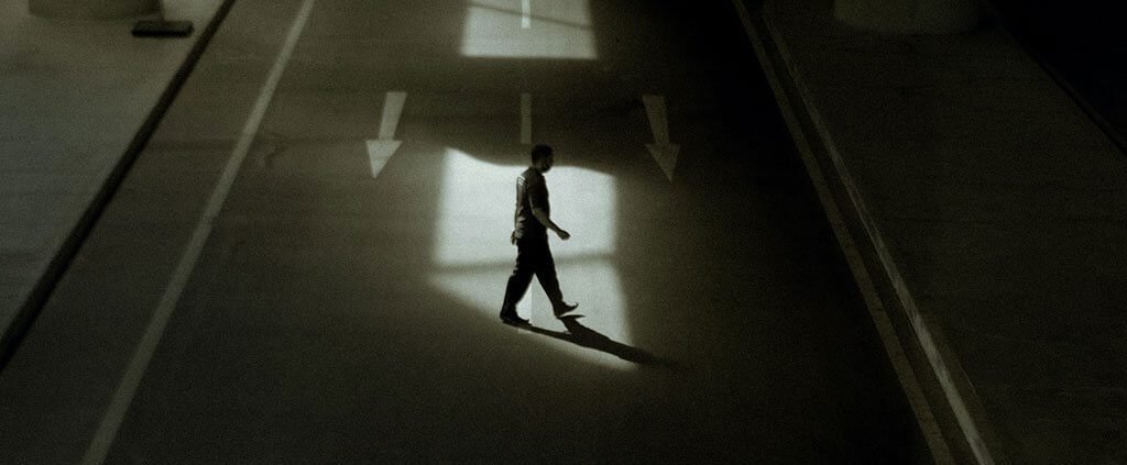 A man walk under a flyover