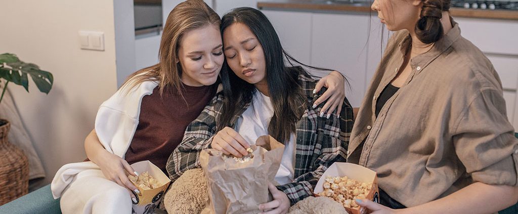 Girl being comforted by friends