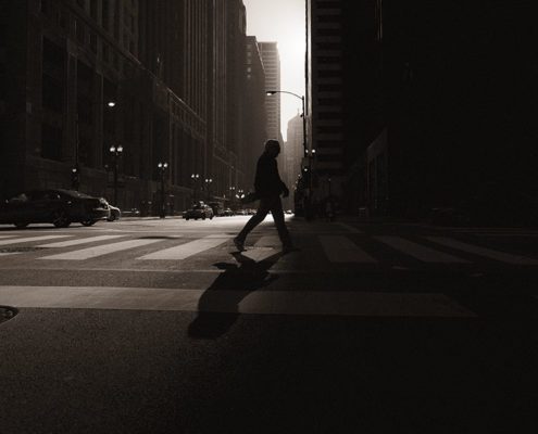 Person walking away from light into darkness