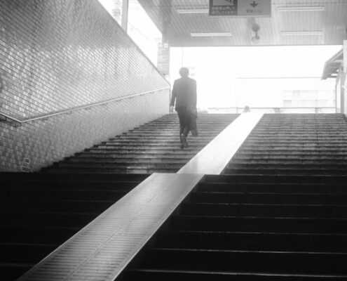 A man is walking out from the underground train station