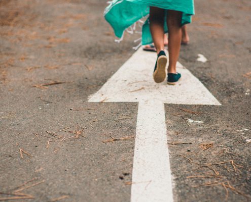 Woman walking on arrow