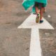 Woman walking on arrow