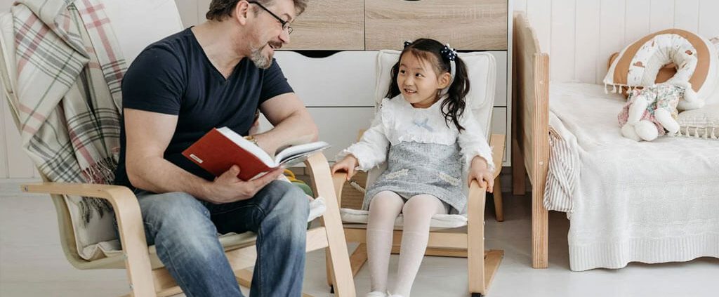 A Caucasian men is teaching his daughter.